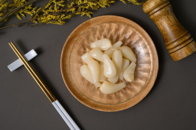 桌面上的盘子里的美味可口的甜酸荞头