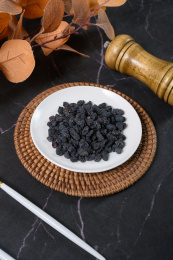 桌面上的盘子里的美味可口的黑加仑葡萄干