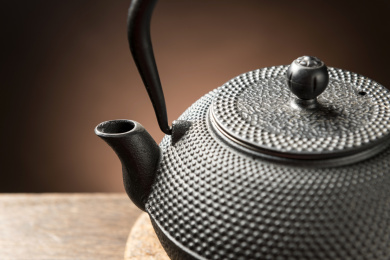 一把铁壶茶具摆放在木桌面上特写