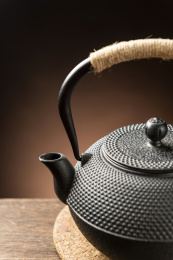 一把铁壶茶具摆放在木桌面上特写