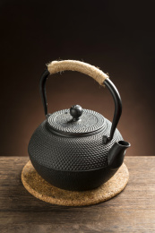 一把铁壶茶具摆放在木桌面上特写