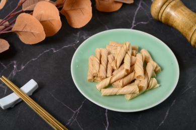 桌面上的盘子里的美味可口的泡发开的豆筋丁