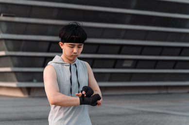 亚洲男生在户外缠拳击绷带