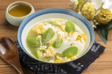 一碗丝瓜鸡蛋汤摆放在桌面上特写