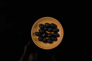 桌面上的盘子里的美味可口的黑橄榄