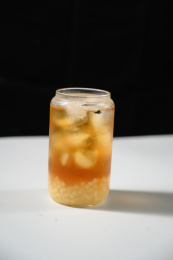 桌面上的杯子里的美味可口的冰蜜桃乌龙茶