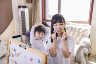 客厅里正在做游戏的姐弟俩