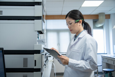 女年轻研发人员在实验室使用平板电脑工作