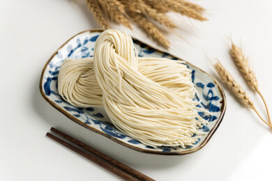 一盘生面条摆放在桌面上特写