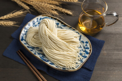 一盘生面条摆放在桌面上特写