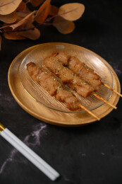 桌面上的盘子里的美味可口的炸猪肉串