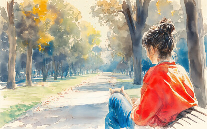 一个女孩和小猫在公园座椅上休息