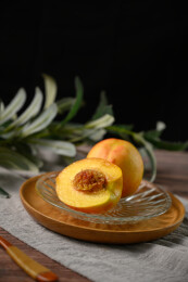 桌面上的盘子里的美味可口的切半黄桃