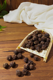 木纹桌上放着余甘果干