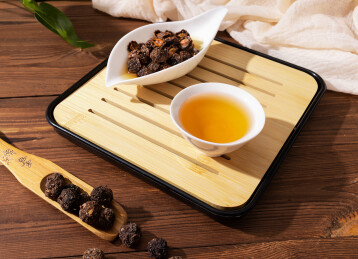 木纹桌上放着余甘果干