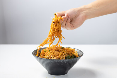 用手正在拌的大碗里的小吃干拌面麻辣凉面