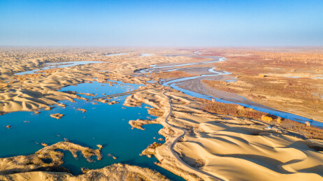 航拍中国新疆尉犁罗布人村寨塔里木河与沙漠