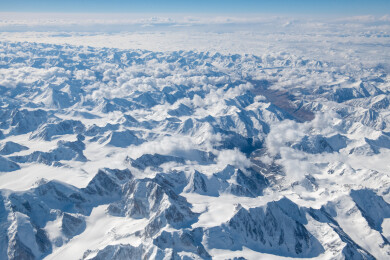 俯拍中国新疆喀什地区云雾缭绕的雪山风景