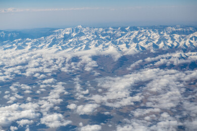 俯拍中国新疆喀什地区云雾缭绕的雪山风景