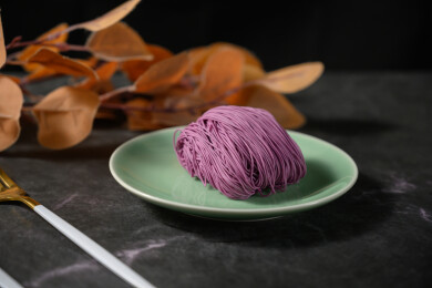 桌面上的盘子里的美味可口的紫薯竹升面