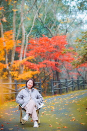 中国女性在浙江宁波奉化溪口杜鹃谷欣赏红枫