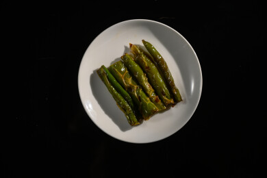 桌面上的盘子里的美味可口的虎皮辣椒