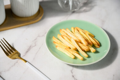 桌面上的盘子里的美味可口的薯条