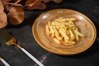 桌面上的盘子里的美味可口的薯条