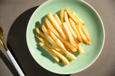 桌面上的盘子里的美味可口的薯条