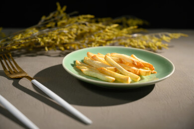 桌面上的盘子里的美味可口的薯条