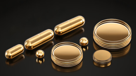 深色背景中金色胶囊和药丸