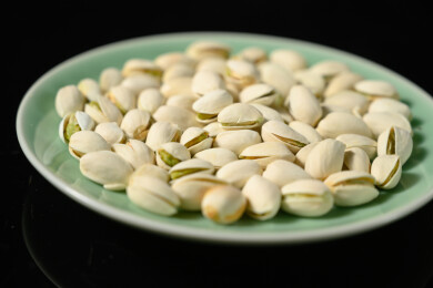 桌面上的盘子里的美味可口的开心果