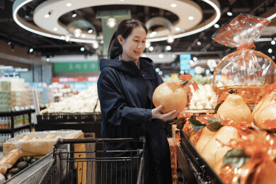 现代杂货店挑选新鲜水果的女人