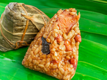 放置在粽叶上的燕麦米蛋黄粽