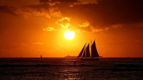 海边日落时的帆船剪影