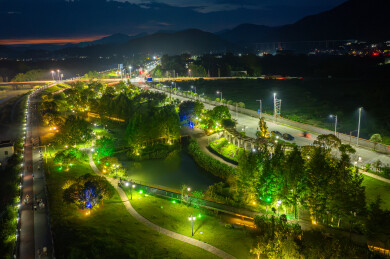 市民在城市湿地公园夜景中散步