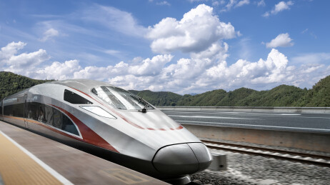 高速列车在蓝天白云下行驶