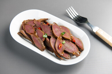 一盘卤鸭胗摆放在桌面上特写