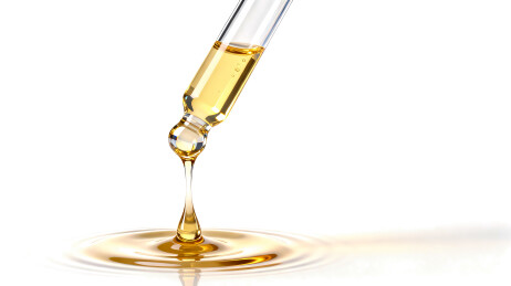 滴管里的黄金精华液背景