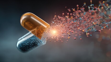 爆炸的黄蓝色药丸胶囊与彩色元素