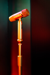 KTV里的立式麦克风金属话筒和背景的电视