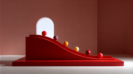 红色斜坡上的彩色球体装置