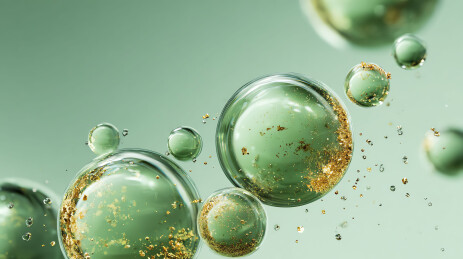 绿色液滴中闪耀金箔的奢华护肤概念图