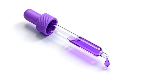 紫色液体滴管滴落瞬间特写图像