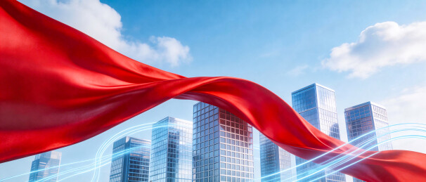 红色绸带飘扬城市高楼背景