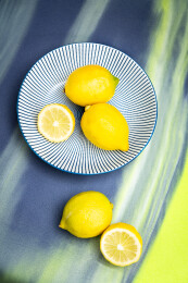 一盘柠檬放在灰绿色背景上