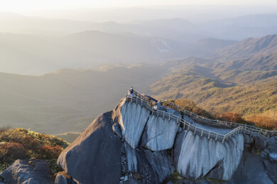 航拍广西桂林猫儿山顶夕阳中的山巅
