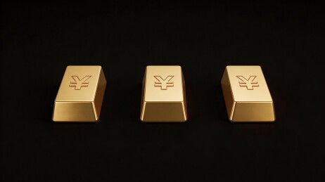 三根刻有日元符号的金条并列摆放