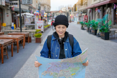 女性旅行者在街上看旅行地图
