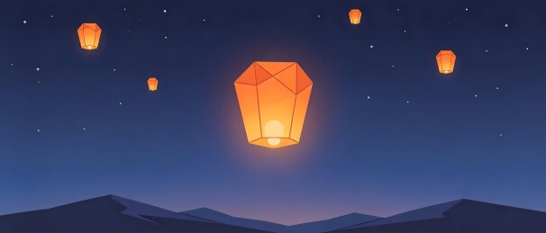 夜空中的孔明灯与山脉剪影